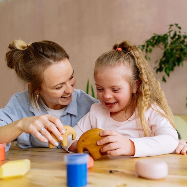 child playing with teacher child playing with teacher