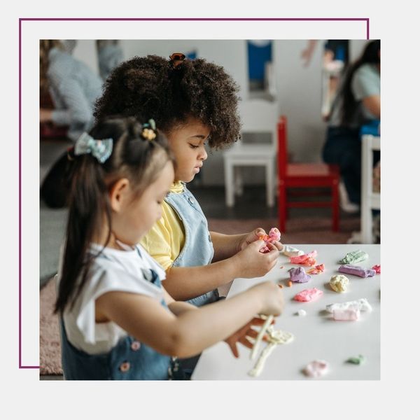 two girls playing with clay