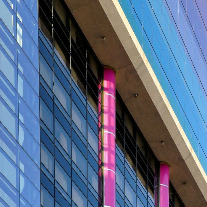 bright purple columns on glass building