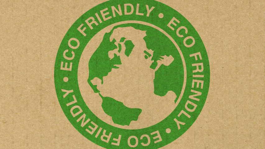 A green eco friendly label stamped on cardboard
