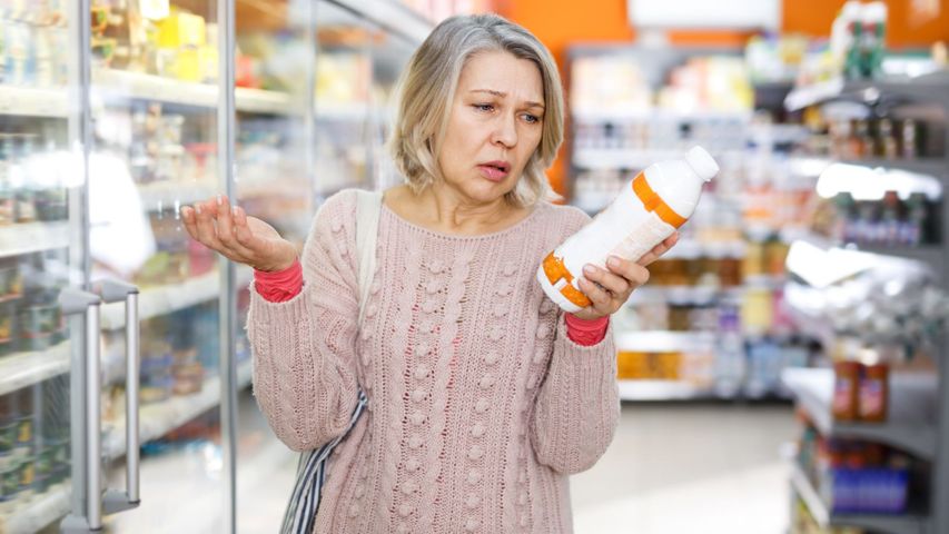 woman looking confused while looking at label