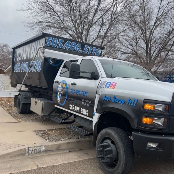truck towing roll-off dumpster