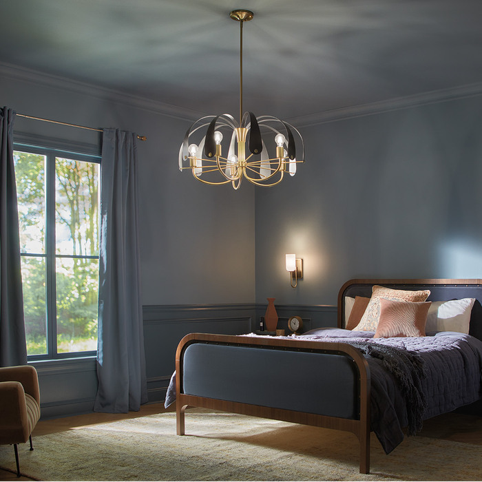A dim chandelier hanging in a blue bedroom