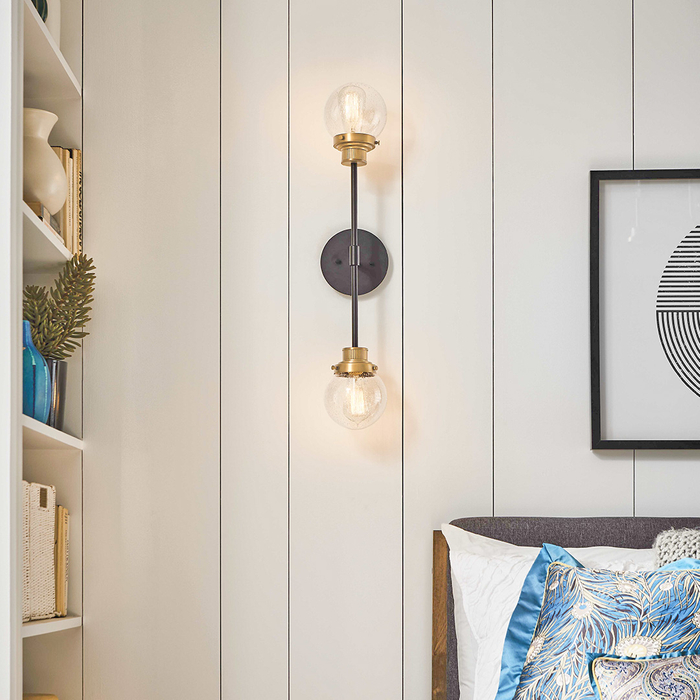 Industrial style sconce beside bed