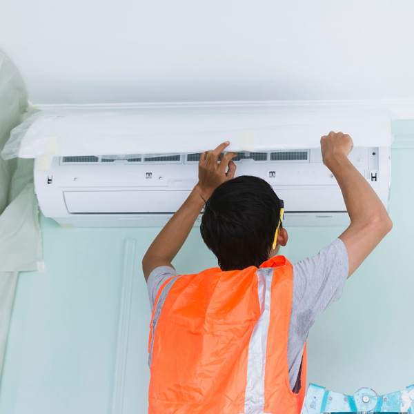 person working on air conditioner