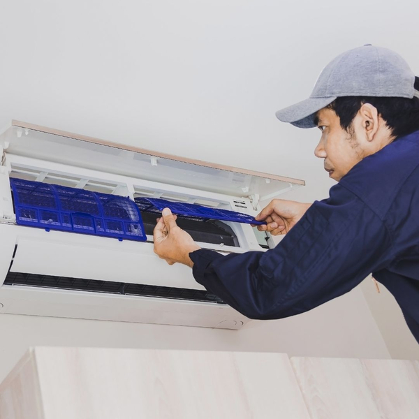 professional changing filter on air conditioner