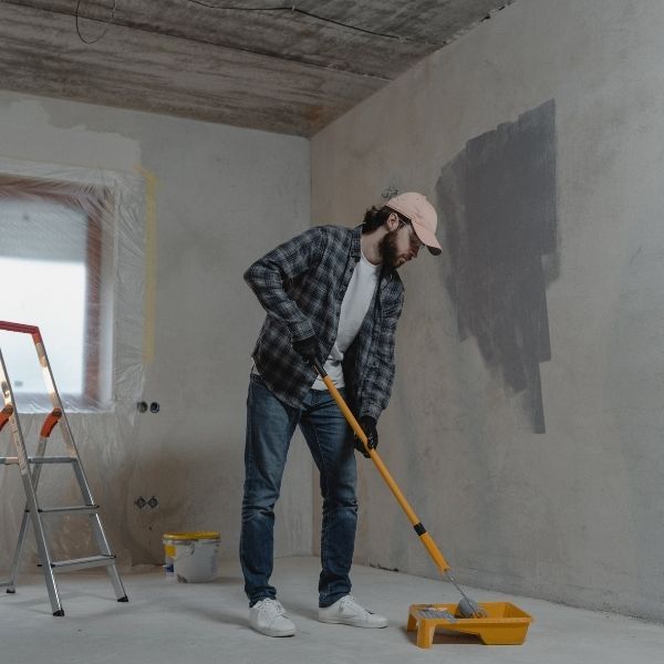 a man painting the inside of a commercial building