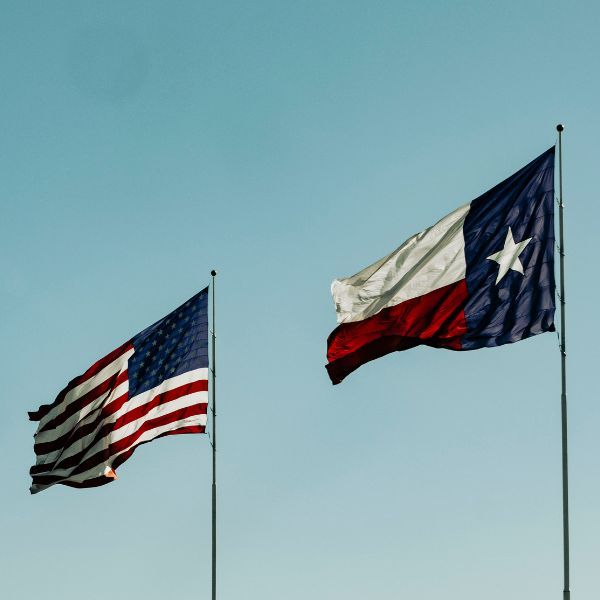 American and Texas state flag flying