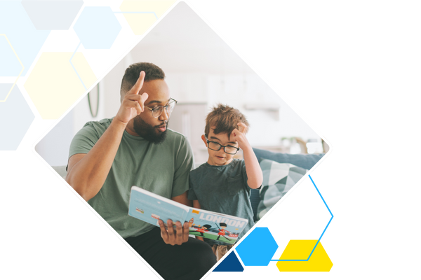 dad and son reading book together 