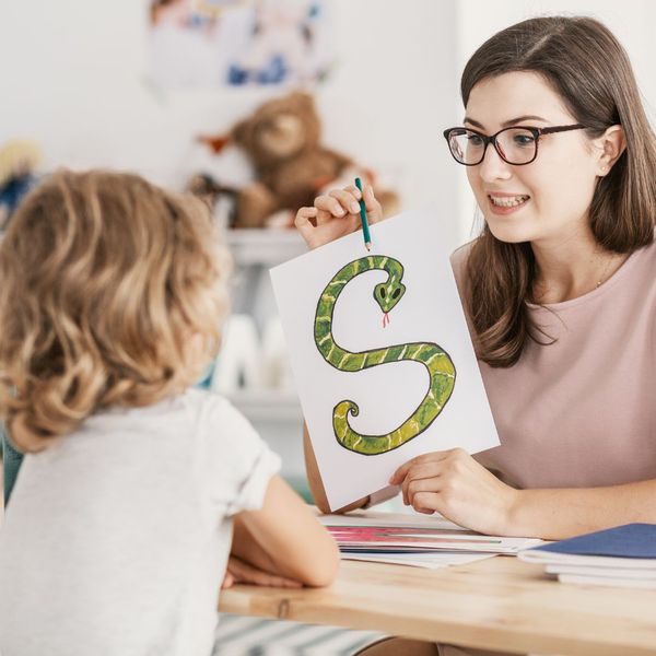 teacher pointing to letter s teacher pointing to letter s
