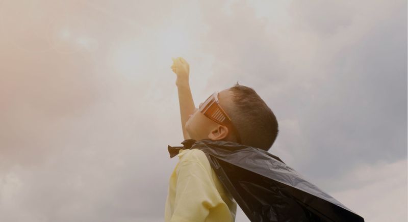 kid with super hero cape 