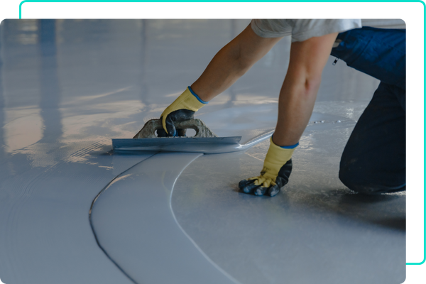 Man spreading epoxy on garage floor