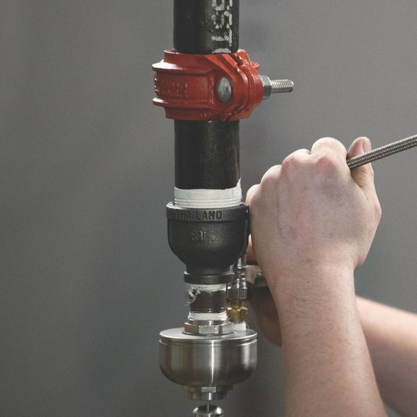 worker installing Victaulic Vortex system worker installing Victaulic Vortex system