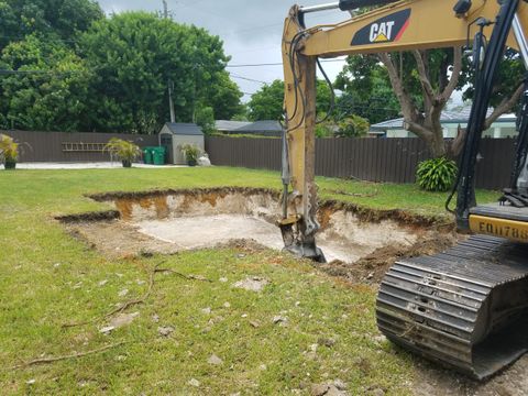 excavation of a pool site in a backyard