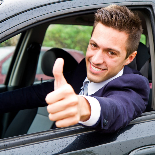 man in car giving thumbs up