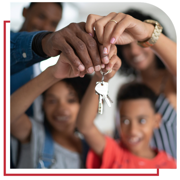 family of 4 holding up their new rented home keys