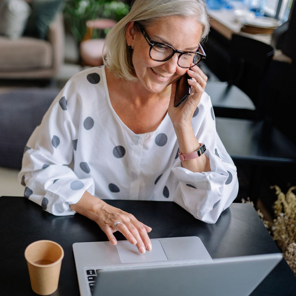 woman talking on phone on computer