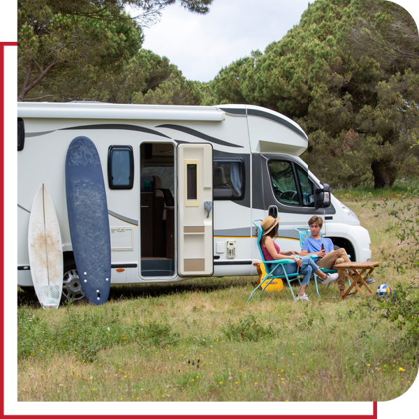 People camping outside an RV.