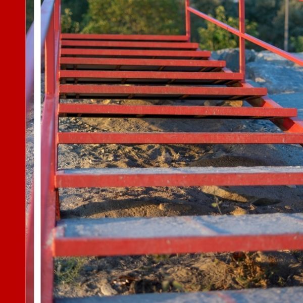 red aluminum staircase going to the beach