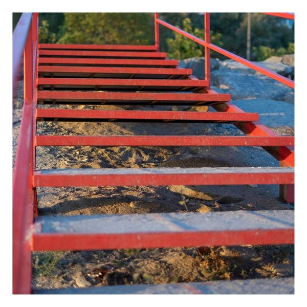 red aluminum stairs going to the beach