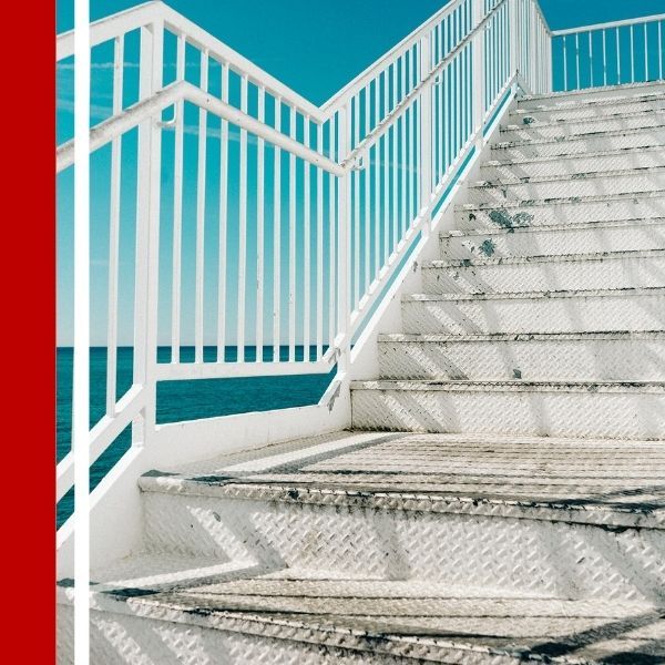 white staircase by the ocean