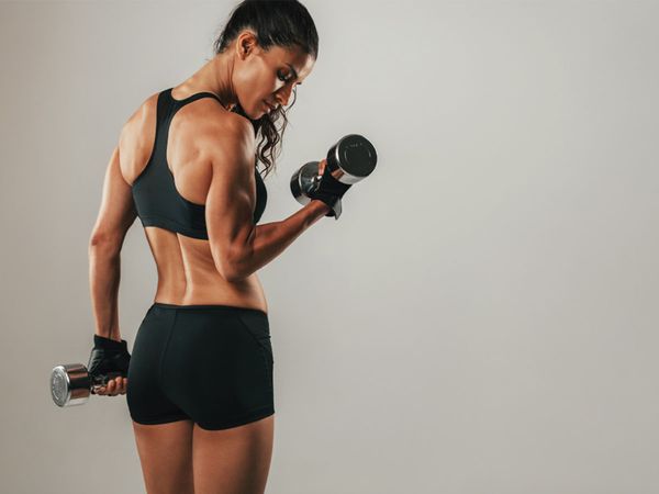  Muscular woman lifting weights. 