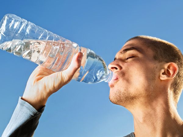 image of man drinking water from a bottle