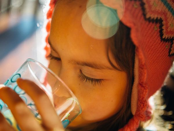 image of a child drinking water from a glass