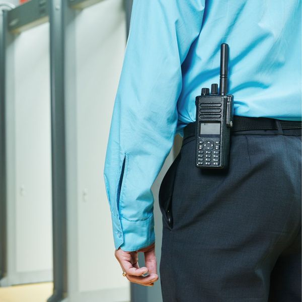 a guard standing in front of metal detectors