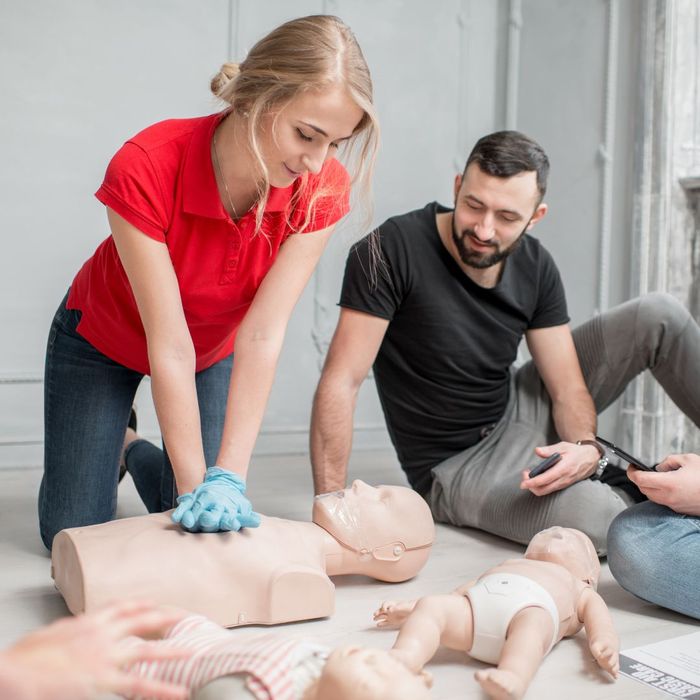 CPR trainer working with students