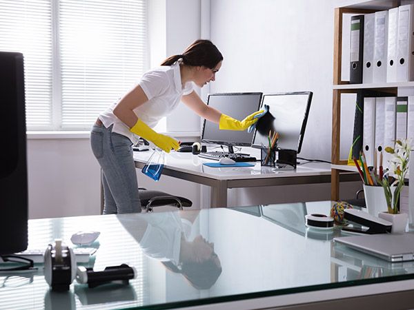 Photo of a woman cleaning an office