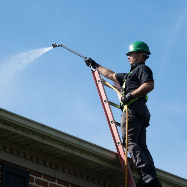 roofer spraying roof