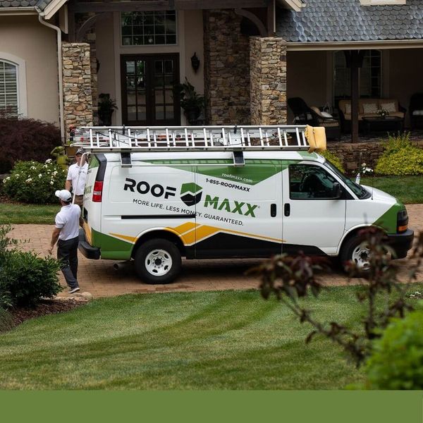 Roof Maxx van in front of a home