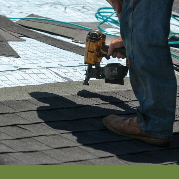 Roofer installing new roof shingles