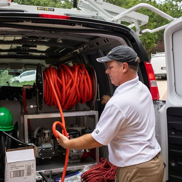 Guaranteed Roof employee preparing for roof restoration