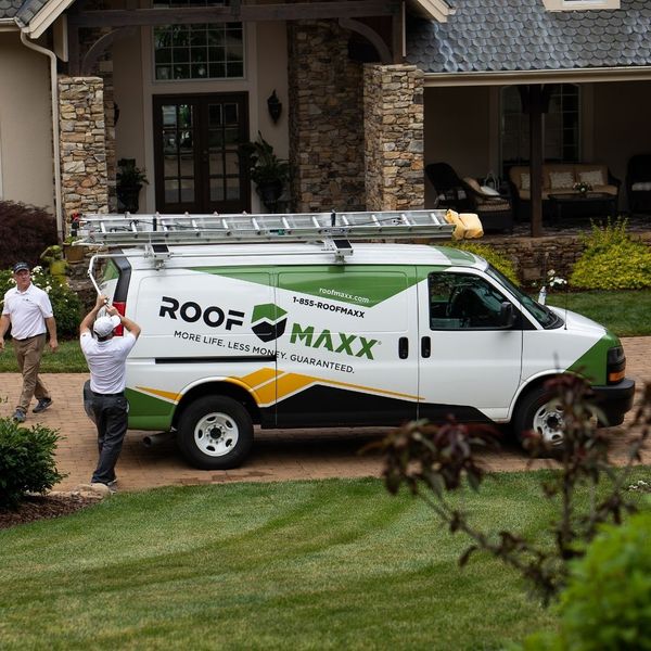 Roof Maxx van in front of a home