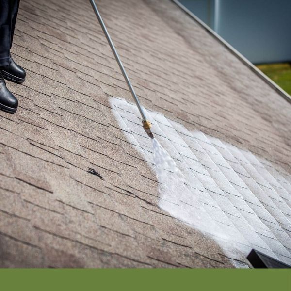roofer applying Roof Maxx to a roof