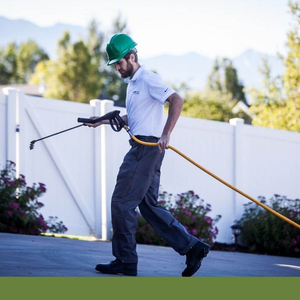 roofer carrying a spraying wand