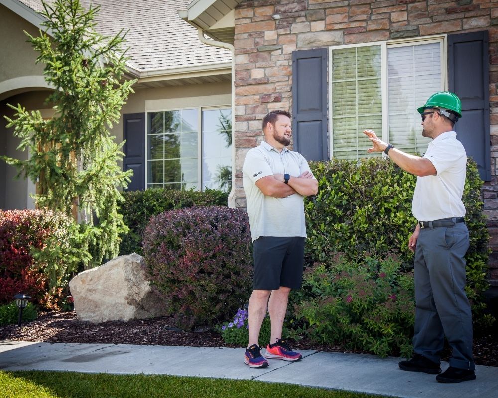 Roofer speaking with home owner Roofer speaking with home owner