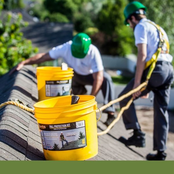 roofers using a fall protection kit roofers using a fall protection kit