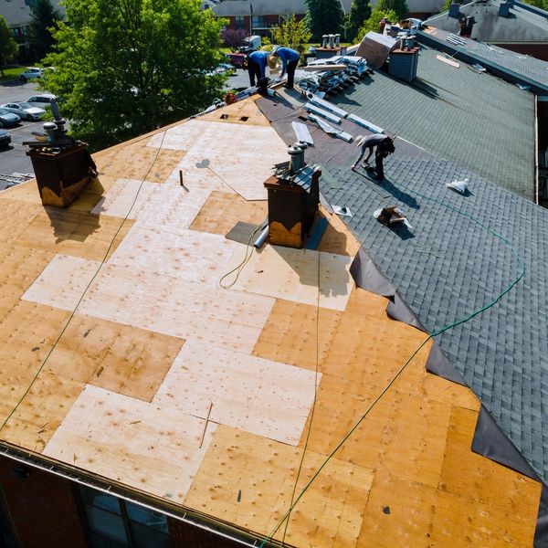 crew replacing roof