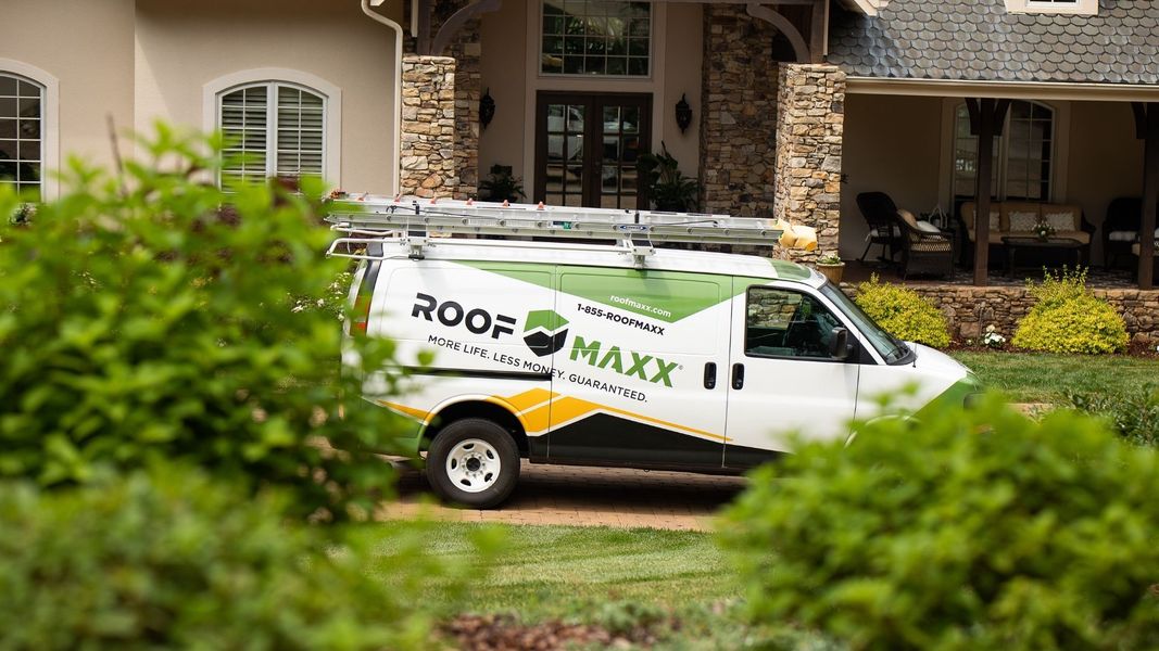 Roof Maxx van in front of a home Roof Maxx van in front of a home