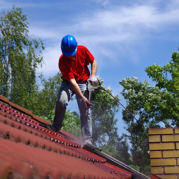 man spraying roof