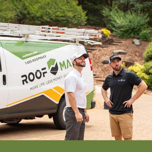 Guaranteed Roof team looking up at a roof