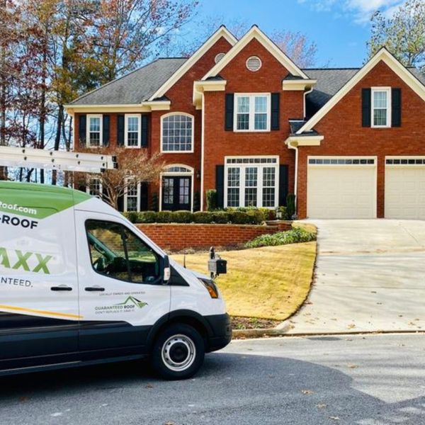 Guaranteed Roof van in front of house