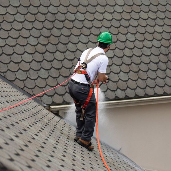 roofer spraying roof