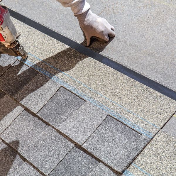 damaged shingles being repaired