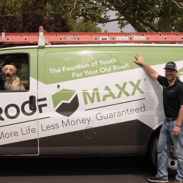 roofer leaning against a truck with a yellow lab sitting in the driver's seat roofer leaning against a truck with a yellow lab sitting in the driver's seat