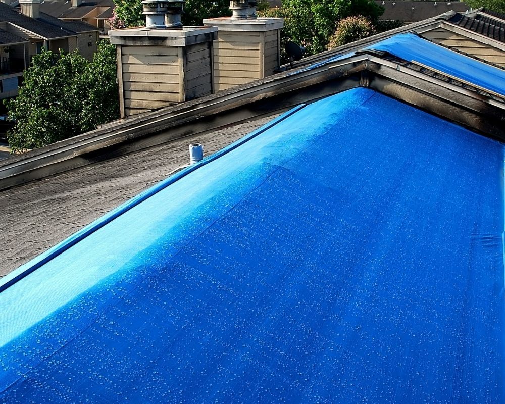 roof covered with blue tarp