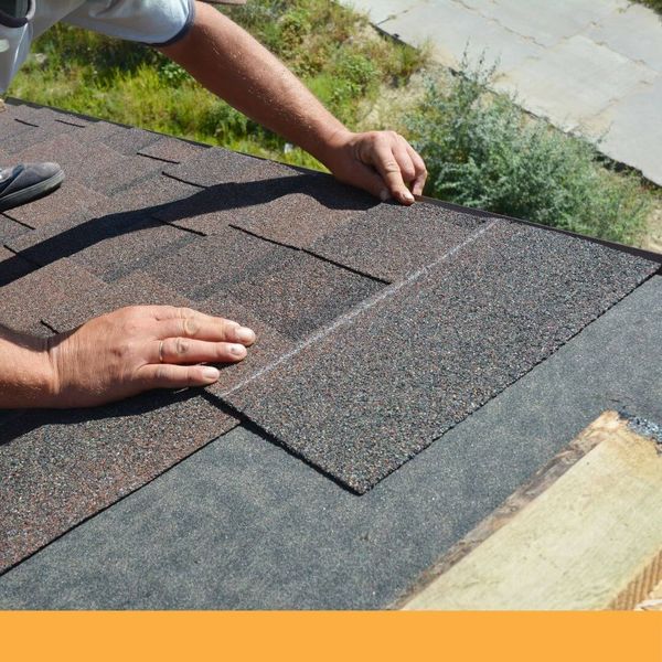 Roofer installing asphalt shingles